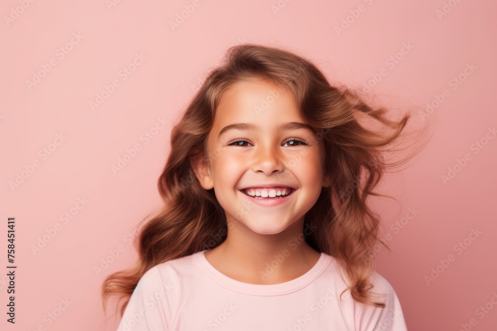 Portrait of a cute little girl with long hair on a pink background Portrait of a cute little girl with long hair on a pink background