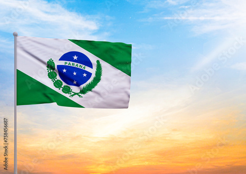 3D illustration of a Parana flag extended on a flagpole and in the background a beautiful sky with a sunset photo