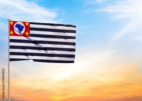 3D illustration of a Sao Paulo flag extended on a flagpole and in the background a beautiful sky with a sunset