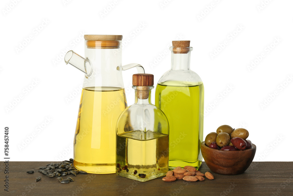 Vegetable fats. Different cooking oils and ingredients on wooden table against white background Vegetable fats. Different cooking oils and ingredients on wooden table against white background