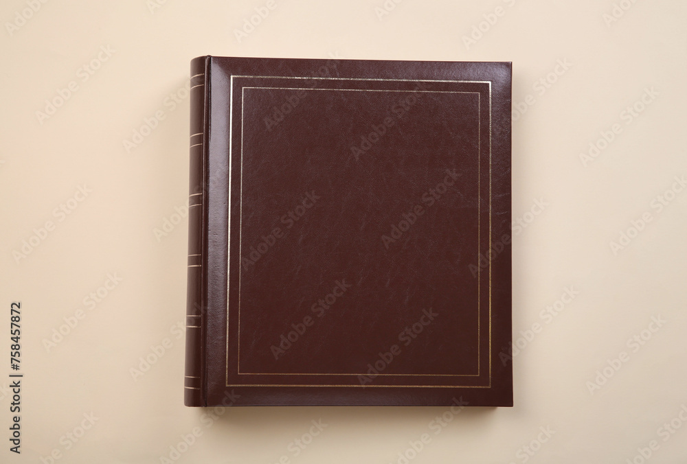 Photo album with leather cover on beige background, top view Photo album with leather cover on beige background, top view