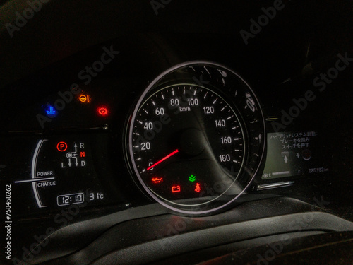 Car speedometer and instrument cluster, various warnings and lights, japanese text, hybrid car with digital displays