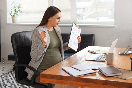 Pregnant businesswoman with...