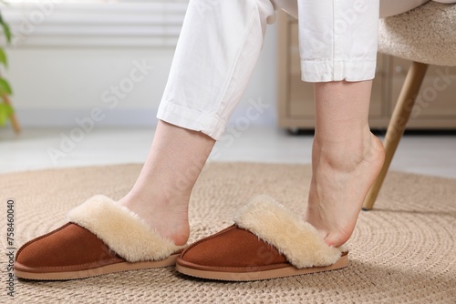 Woman in soft slippers at home, closeup photo
