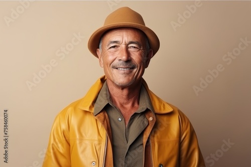 Portrait of a smiling senior man wearing a hat and jacket.