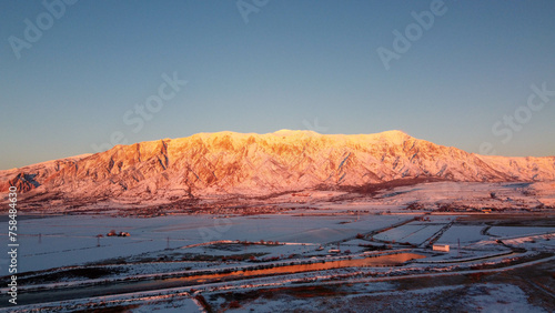 4k Aerial Drone Snow-Capped Mountains Overlooking Willard Bay, Utah photo