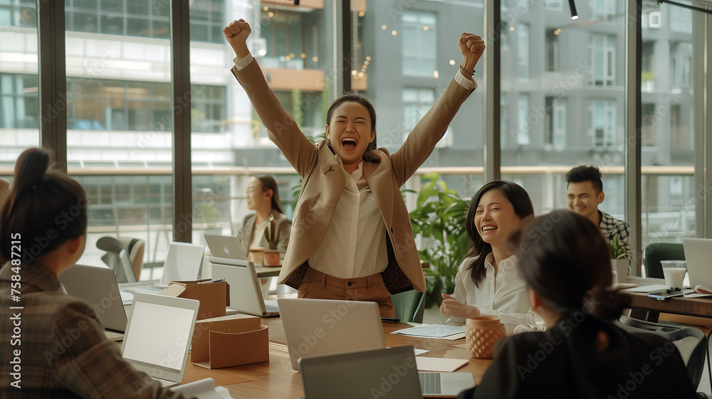 A group of business people are celebrating their success in an office setting, with one person holding up her fist and smiling at the camera. - obrazy, fototapety, plakaty 