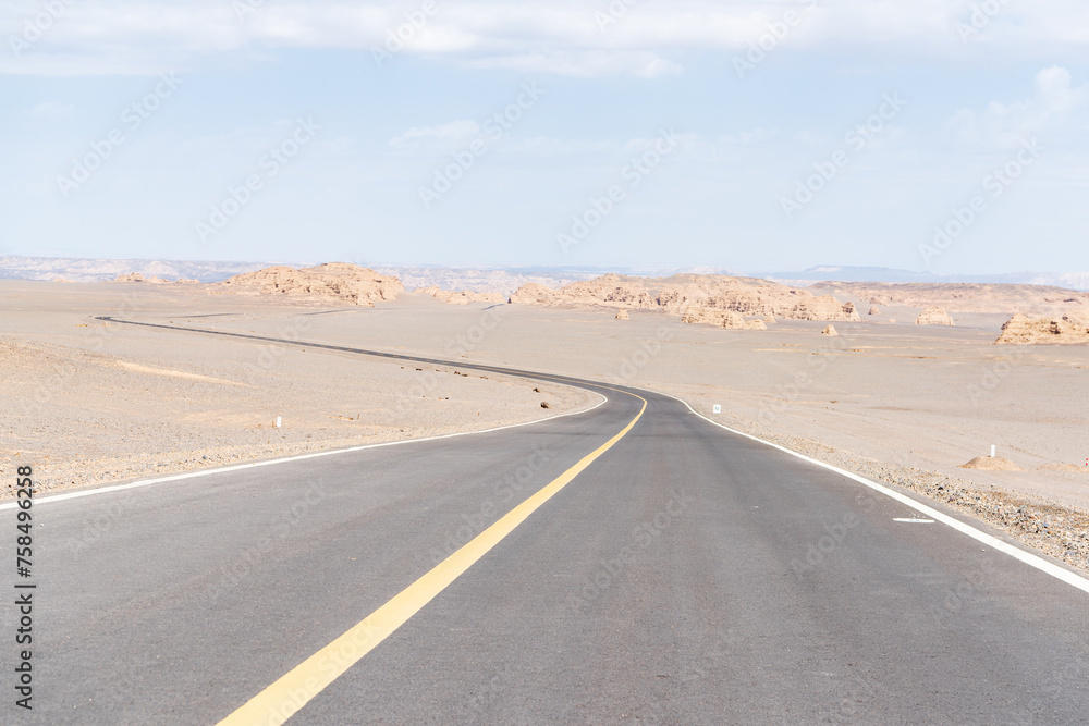Tourist road in the Devil City in Hami, Xinjiang, China Tourist road in the Devil City in Hami, Xinjiang, China
