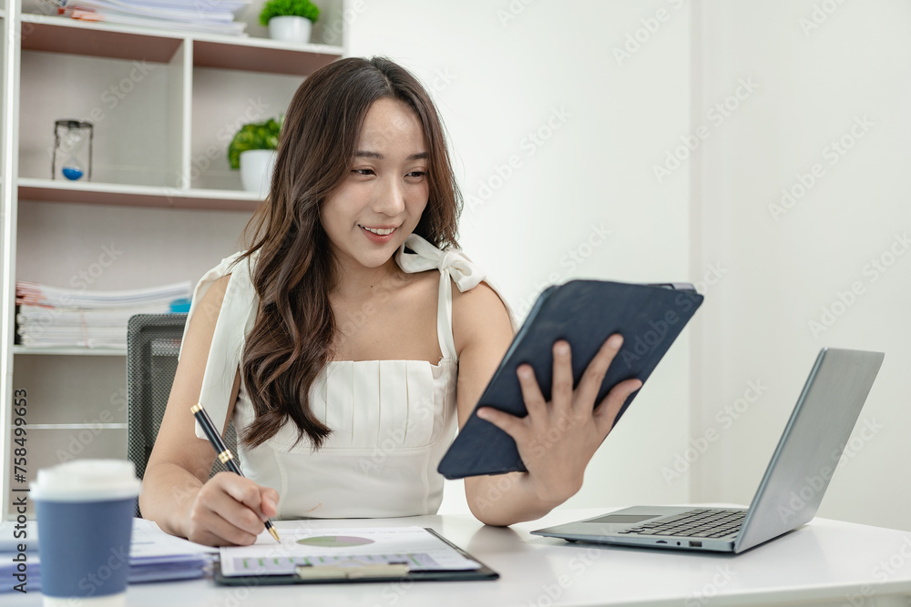 Asian female accountant working on laptop and doing paperwork, tax, trading, and financial consulting and accounting analysis investment information report Financial concepts and tax system Asian female accountant working on laptop and doing paperwork, tax, trading, and financial consulting and accounting analysis investment information report Financial concepts and tax system