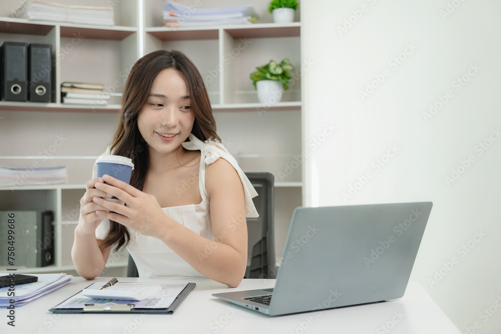 Asian female accountant working on laptop and doing paperwork, tax, trading, and financial consulting and accounting analysis investment information report Financial concepts and tax system Asian female accountant working on laptop and doing paperwork, tax, trading, and financial consulting and accounting analysis investment information report Financial concepts and tax system