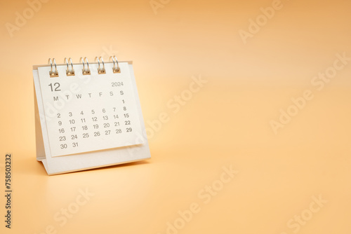 Simple desk calendar for December 2024 isolated on orange background. Calendar concept with copy space.