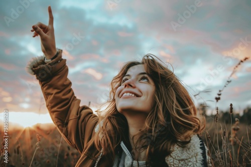 Portrait of woman pointing the sky, Conceptual image of hope and positive energy