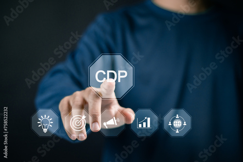 CDP, Customer Data Platform concept. Customer data for analysis, collection Customer information and martech tools. Businessman touching CDP icon on virtual screen. photo