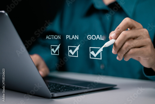 Goal, plan and action concept. Business strategy and business development. Businessman using laptop to checking mark on checkboxes on virtual screen.
