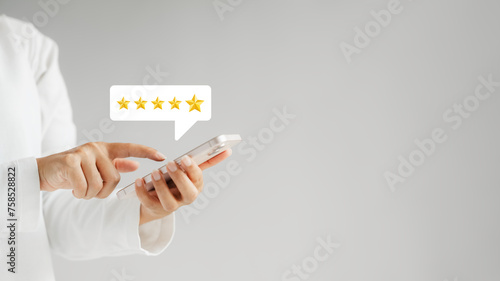 customer satisfaction survey concept businesswoman use smartphone Touch the happy smiley icon. Satisfied. 5 stars. Service experience rating. online application Satisfaction Review best quality..