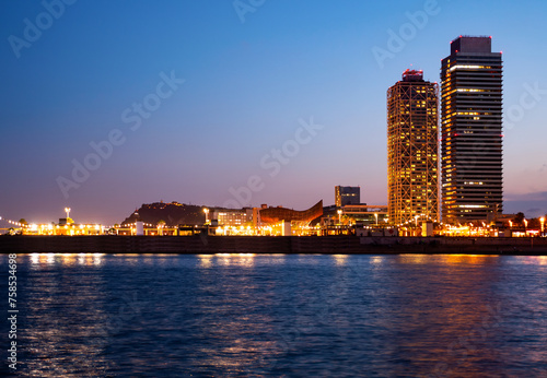 Urban landscape of Barcelona with view of Olympic Harbour and twin towers in evening time.