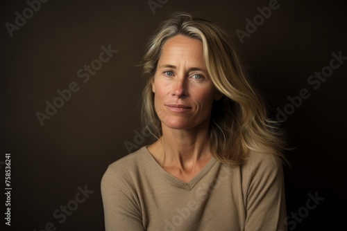 Portrait of a beautiful woman with blonde hair on a dark background