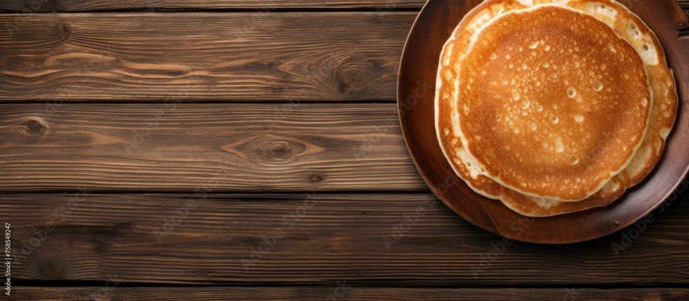 A stack of pancakes sits on a plate atop a wooden table made from hardwood. The table has a rich brown wood stain and varnish, showcasing its natural grain pattern A stack of pancakes sits on a plate atop a wooden table made from hardwood. The table has a rich brown wood stain and varnish, showcasing its natural grain pattern