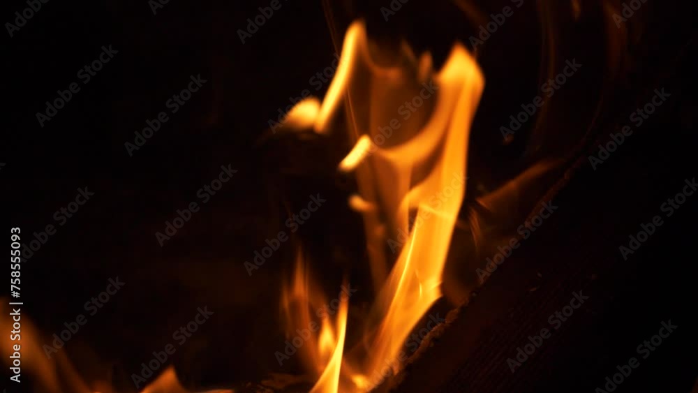 Burning wood log, with vibrant fire flames, extreme close-up slow motion video. Burning wood log, with vibrant fire flames, extreme close-up slow motion video.