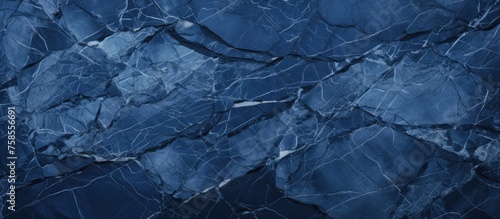 A detailed closeup of a liquid, electric blue marble texture resembling a frozen landscape with ice caps, rocks, and patterns like frost on a cold winter sky photo