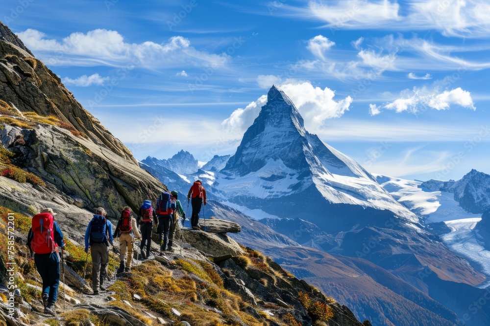 Group of mountain guides leading a group of hikers up a rugged trail to the summit of a majestic peak, with panoramic views of snow-capped mountains and alpine meadows, Generative AI