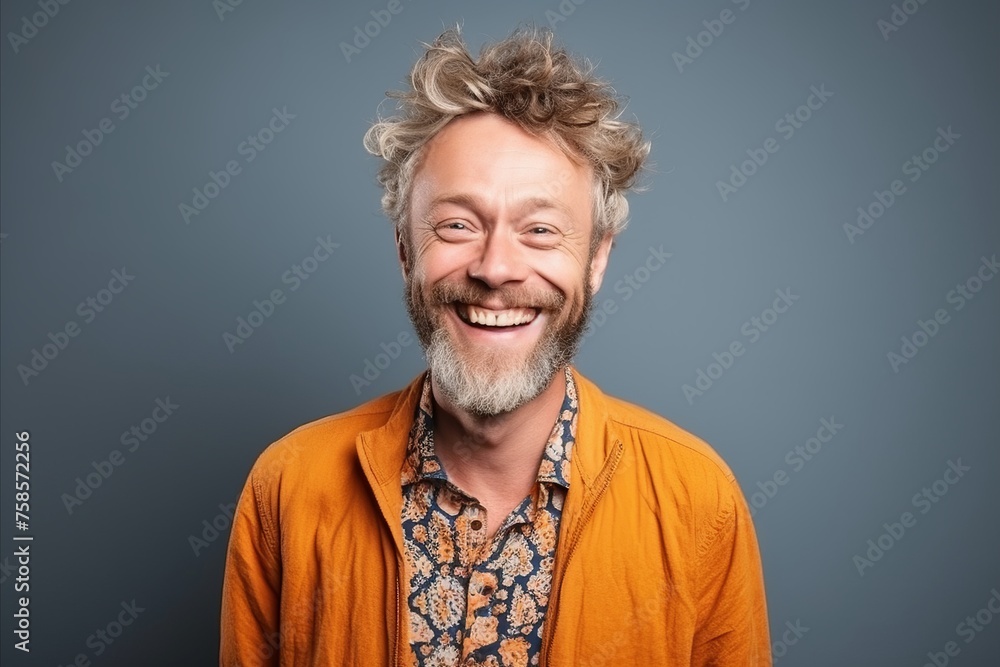 Portrait of a happy senior man smiling at the camera over grey background