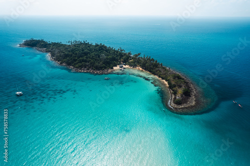 Tropical island from above and clear blue sea