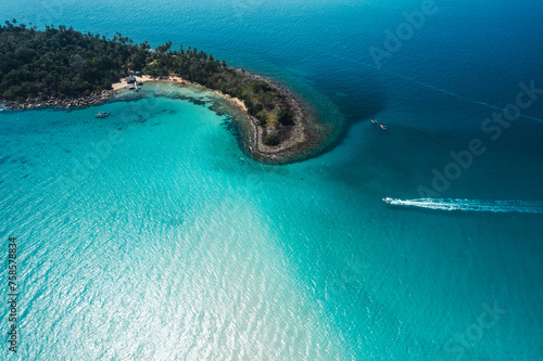 Tropical island from above and clear blue sea