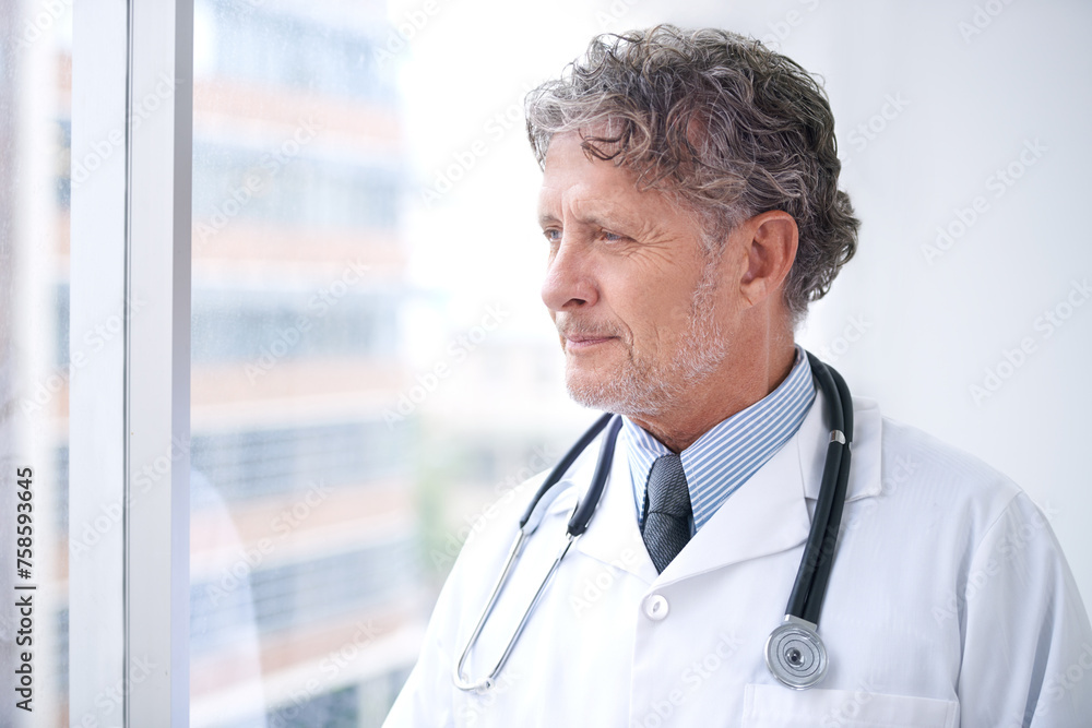 Doctor, thinking and man at window in office planning future surgery or ideas for medical process in clinic. Medicine, innovation and mature surgeon remember a solution in healthcare and hospital Doctor, thinking and man at window in office planning future surgery or ideas for medical process in clinic. Medicine, innovation and mature surgeon remember a solution in healthcare and hospital