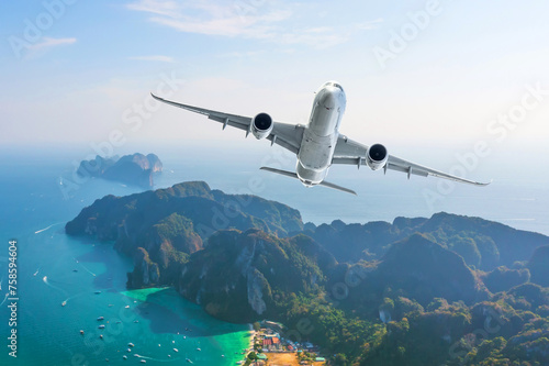 Jet plane fly over the tropical island. Panoramic view airliner landing take off flight to exotic islands in the warm ocean, vacation travel trip concept