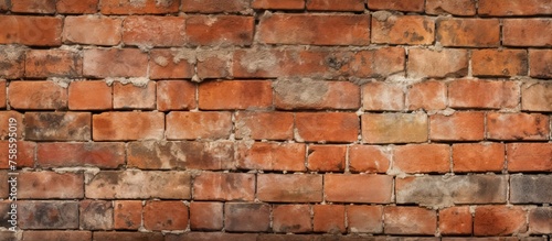 A closeup shot of a brown brick wall showcasing the intricate brickwork of the facade. The rectangular bricks are arranged in a composite pattern with a wooden font