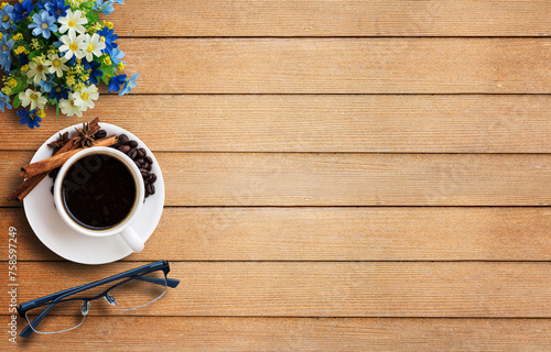 Coffee cup and glasses on wooden table photo