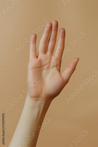 Hand is raised in air with fingers spread out