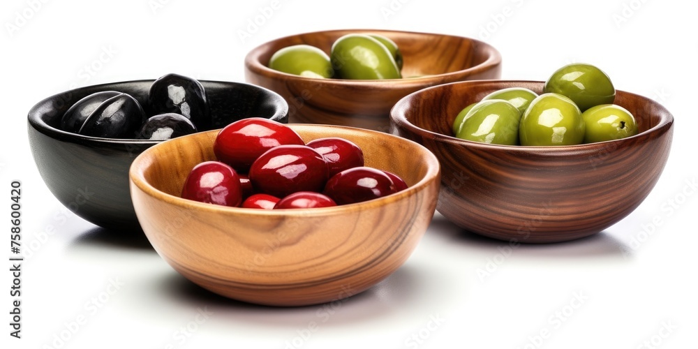 Four wooden bowls filled with different colored olives Four wooden bowls filled with different colored olives