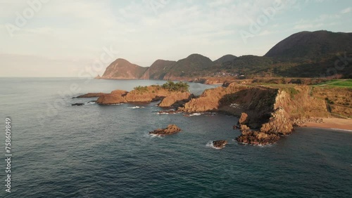 Aerial drone fly above blue peninsula of Kyotango Kyoto Japan Travel landscape sea water floating slowly in Panoramic clean environment, mountain range background photo