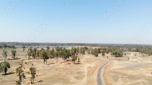 Aerial shot of barren land with asphalt road and water at a distance in Charu village in Chatra, Jharkhand, India. Jharkhand Tourism. photo