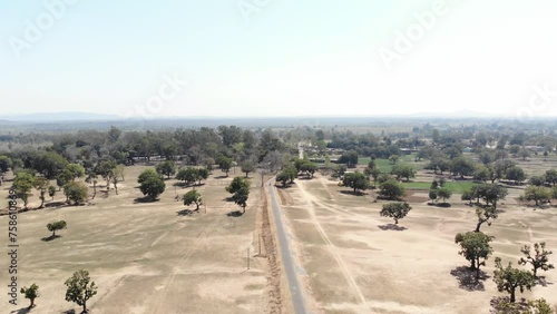 Aerial shot of barren arid land with asphalt road in Charu village in Chatra, Jharkhand, India. photo