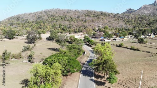 Aerial shot of beautiful village and a concrete road passing from the middle of the village in Charu, Chatra, Jharkhand, India. Jharkhand tourism. photo
