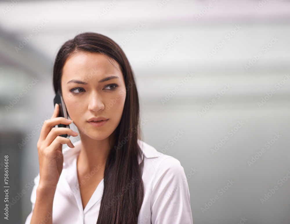 Face, phone call and serious with business woman in corporate office for communication or networking. Concern, problem solving and thinking with worried young employee talking on mobile in workplace Face, phone call and serious with business woman in corporate office for communication or networking. Concern, problem solving and thinking with worried young employee talking on mobile in workplace
