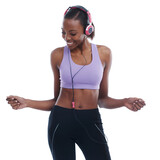 Fitness, music and smile with happy black woman in studio isolated on white background for radio. Exercise, dance and headphones with confident young sports model training for health or wellness