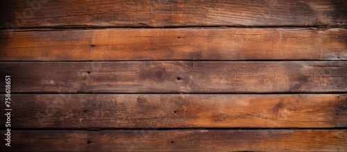 A close up of a brown hardwood plank wall with amber wood stain, showcasing the beautiful tints and shades of the wood grain pattern
