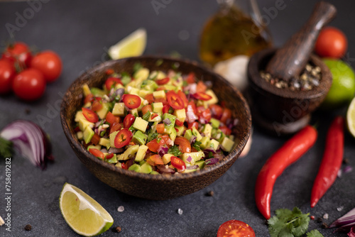 traditional salsa dip snack in wooden bowl on a table with ingredients