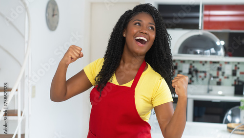 Corpulent african american woman with apron loves cooking at kitchen