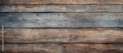 A close up of a brown hardwood plank wall with a blurred background  showcasing the beauty of the building material used in the construction