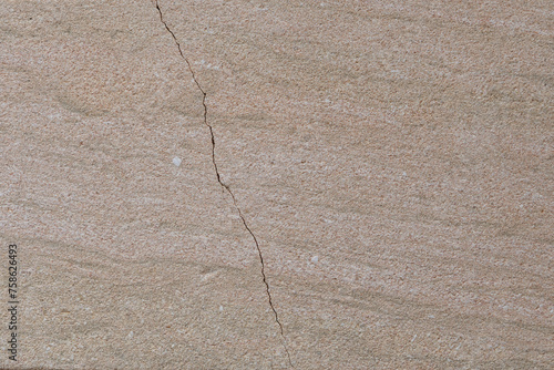 The surface of natural stone is cracked. Can be used as a background