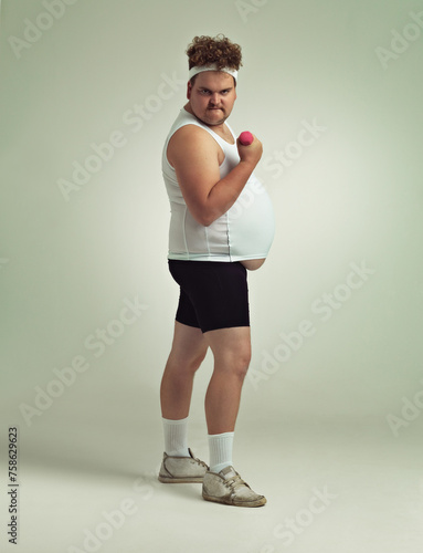 Man, portrait and dumbbell in studio for power, plus size and exercise for weight loss on background. Male person, training and gym equipment for strength, challenge and body development for fitness