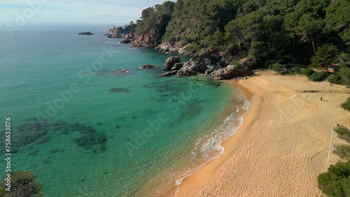 Behold the captivating aerial views of Lloret De Mar's coastline, where transparent blue waters meet sandy shores, inviting luxury travelers to Santa Cristina and Cala Treumal. photo