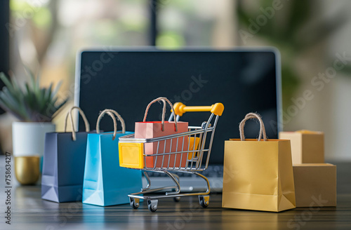 Online Shopping Concept with Cart and Bags in Front of Laptop 