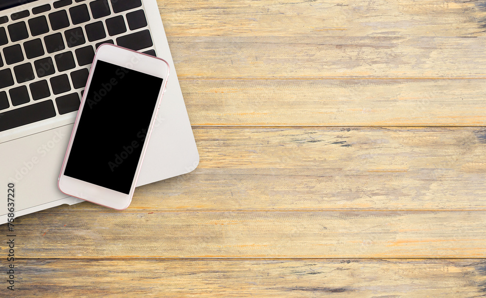 Smart phone and laptop computer on office desk or wood table. Smart phone and laptop computer on office desk or wood table.