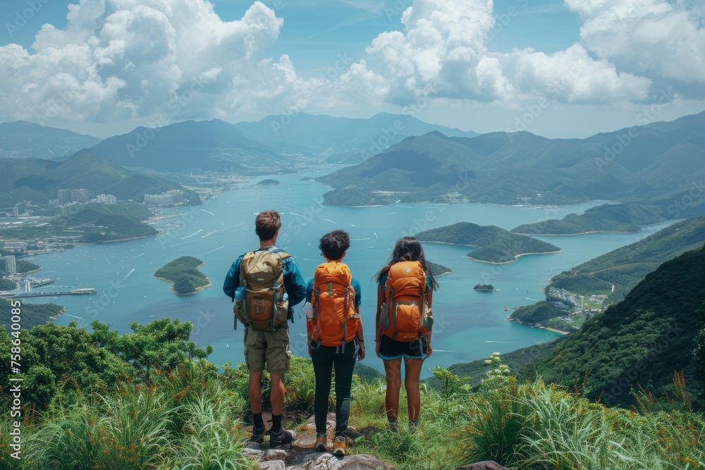 Travelers overlook a stunning seascape from a mountain peak.
